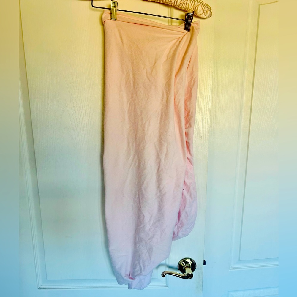 Pink cotton crib sheet.